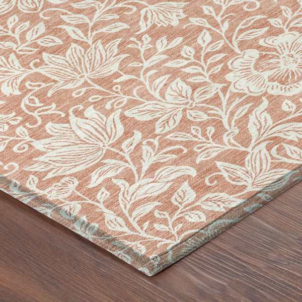 Light coral floral area rug with white botanical pattern, crafted from soft synthetic fibers, ideal for modern decor.