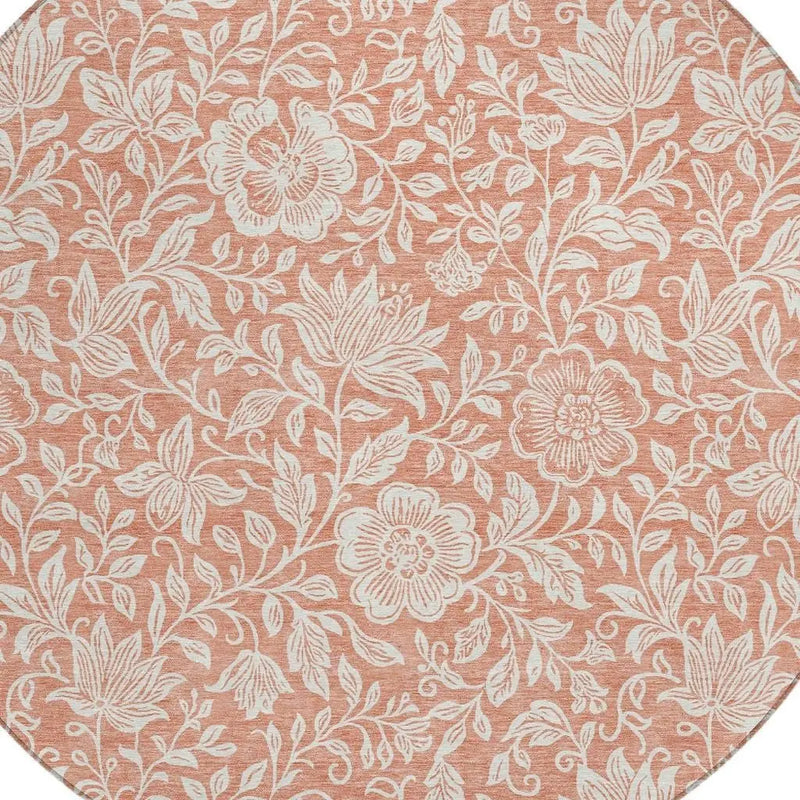 Round pink floral area rug featuring white botanical patterns, perfect for adding a touch of elegance to any room.