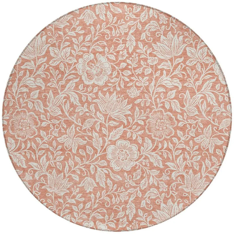 Round floral area rug in soft peach with white botanical designs, perfect for adding warmth to any room.