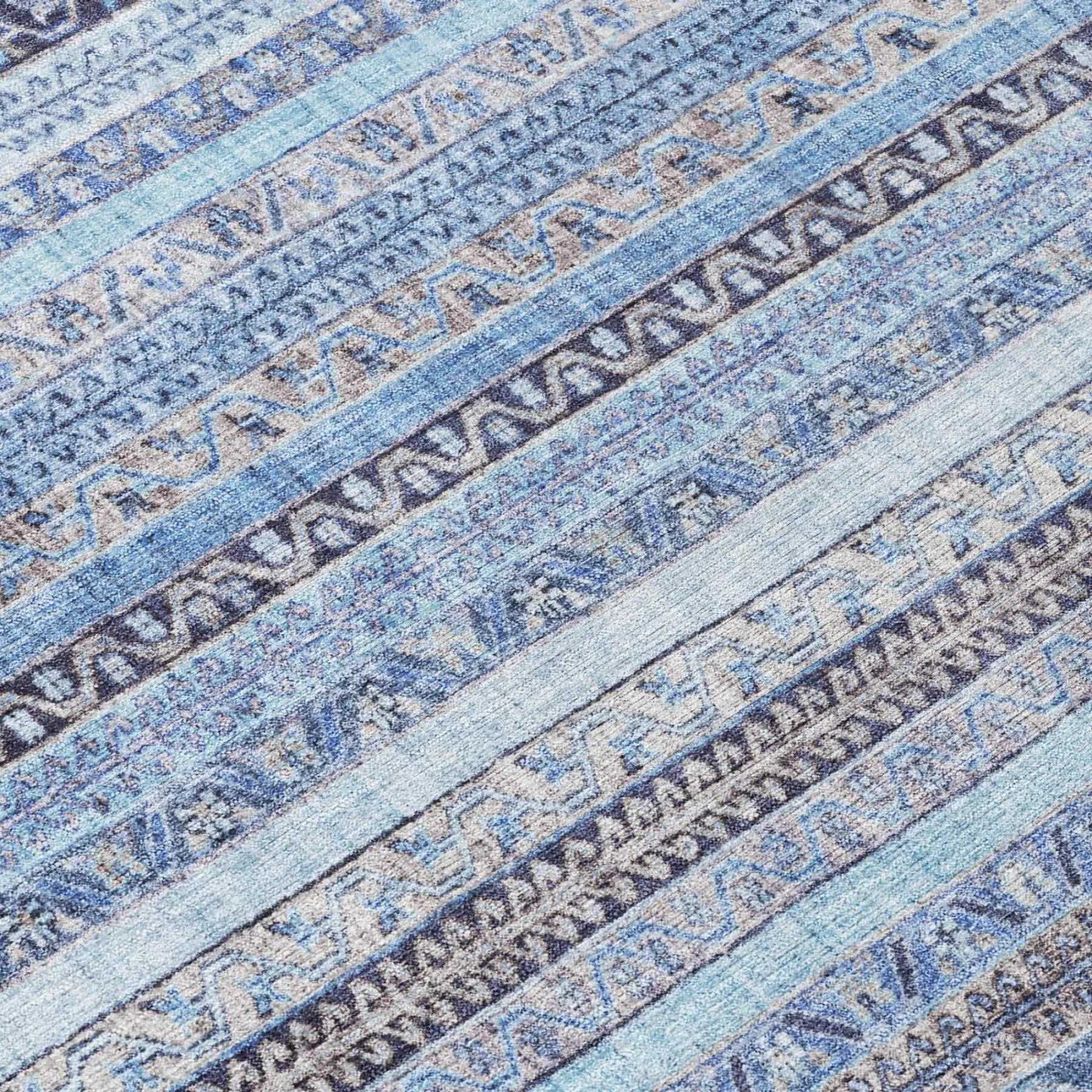 Blue patterned area rug in soft, durable fabric, featuring geometric designs and a cozy, modern style.