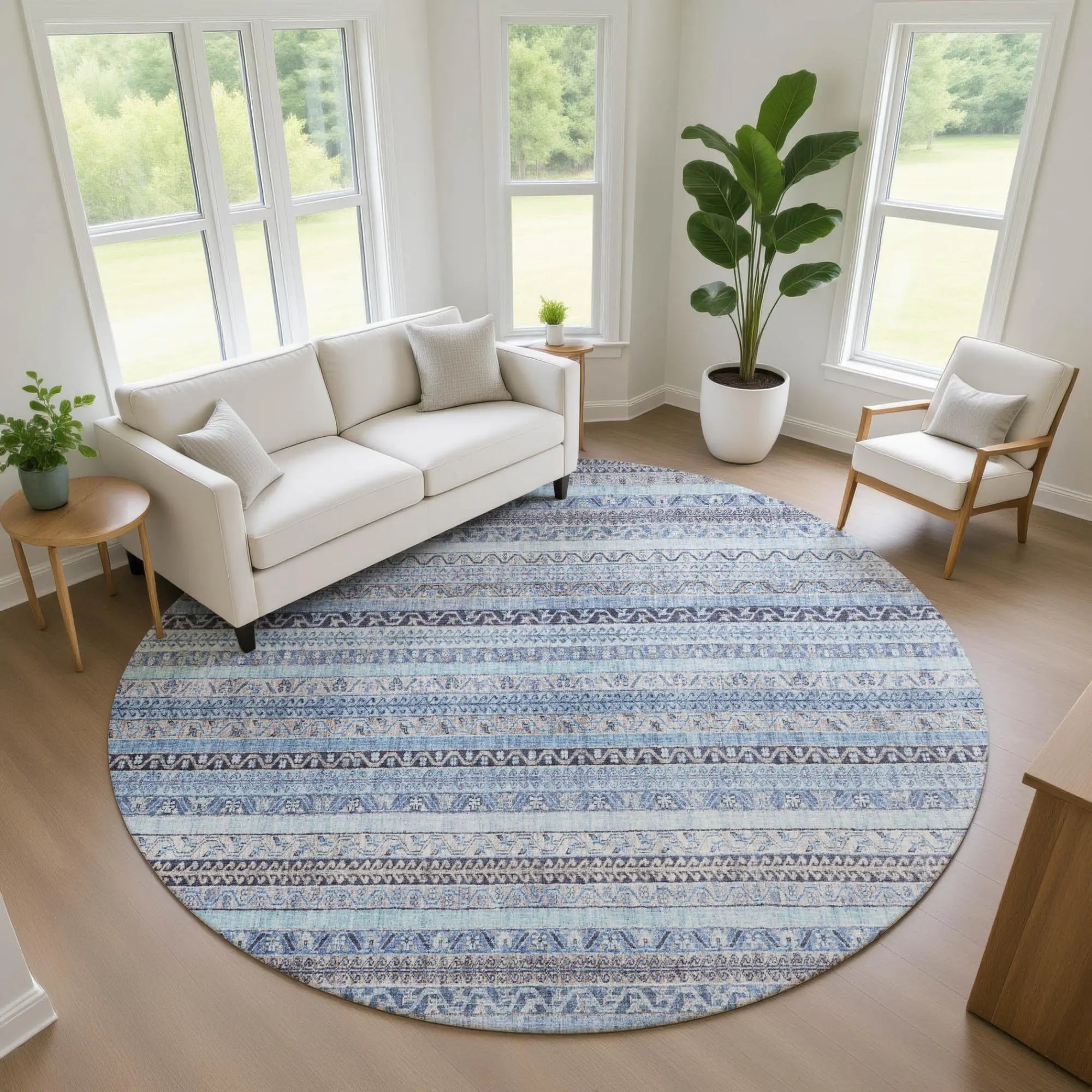 Round blue area rug with intricate patterns, soft fibers, perfect for modern living room decor.