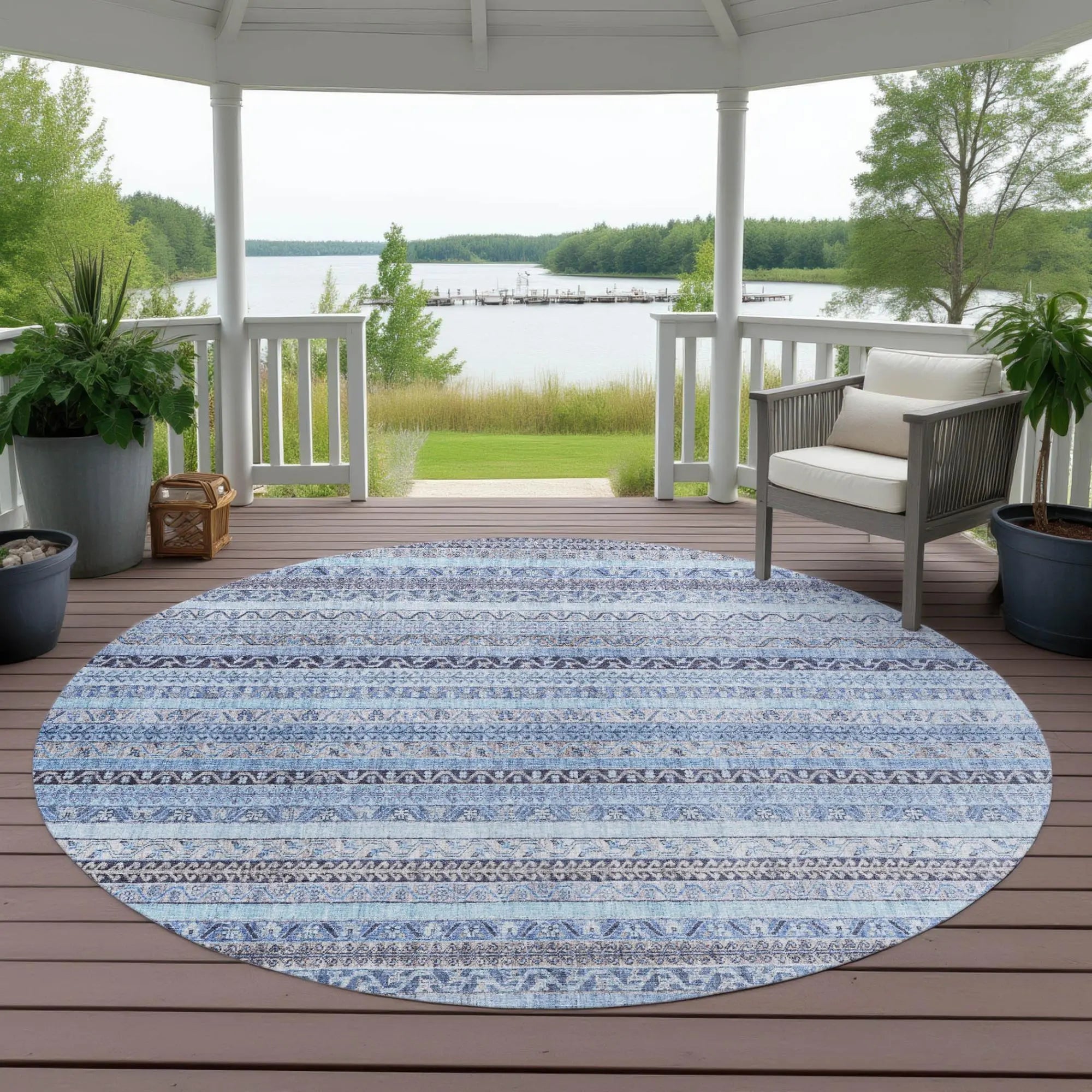 Round blue patterned outdoor rug, featuring intricate tribal designs, ideal for patio decor.