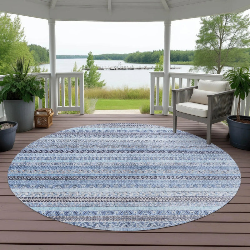 Round blue patterned outdoor rug, featuring intricate tribal designs, ideal for patio decor.