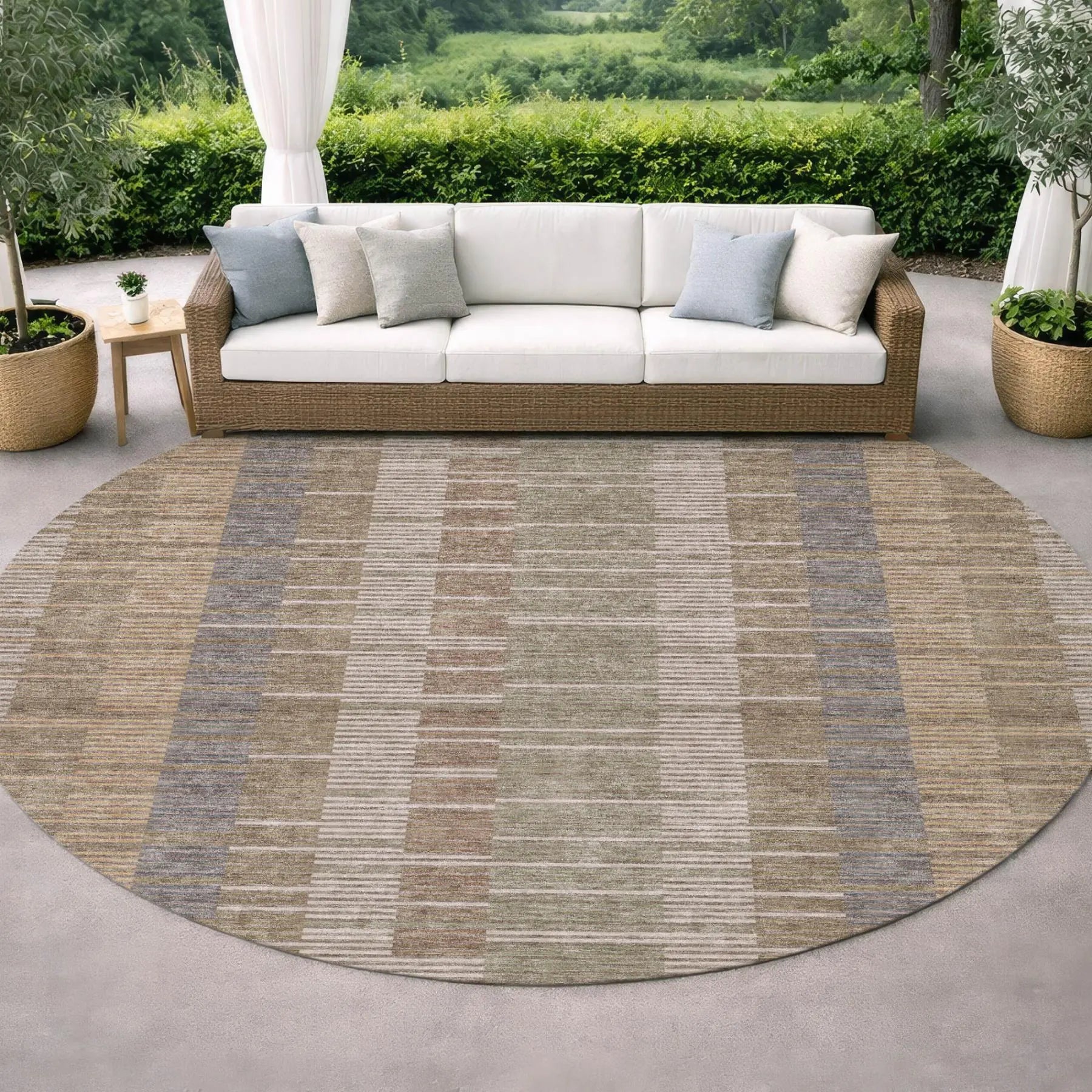 Round outdoor rug in muted earth tones, featuring stripes in beige, gray, and brown, perfect for patio decor.