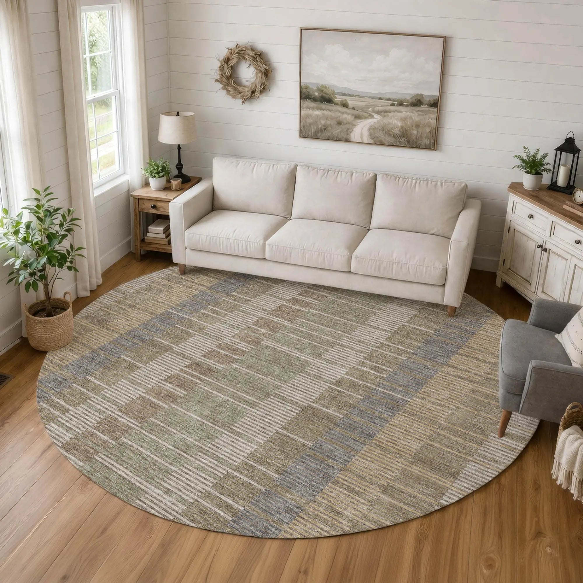 Round area rug in beige, blue, and green stripes, perfect for modern living rooms and cozy spaces. Soft, durable material.