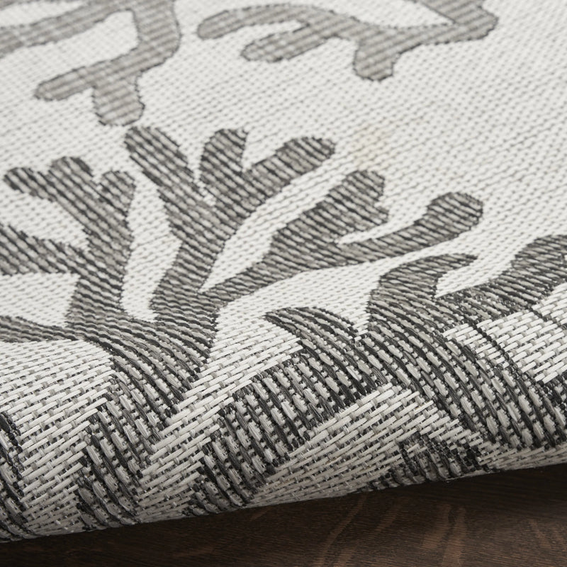 Gray and white woven area rug with coral pattern, perfect for modern decor. Durable, stylish, and versatile design.