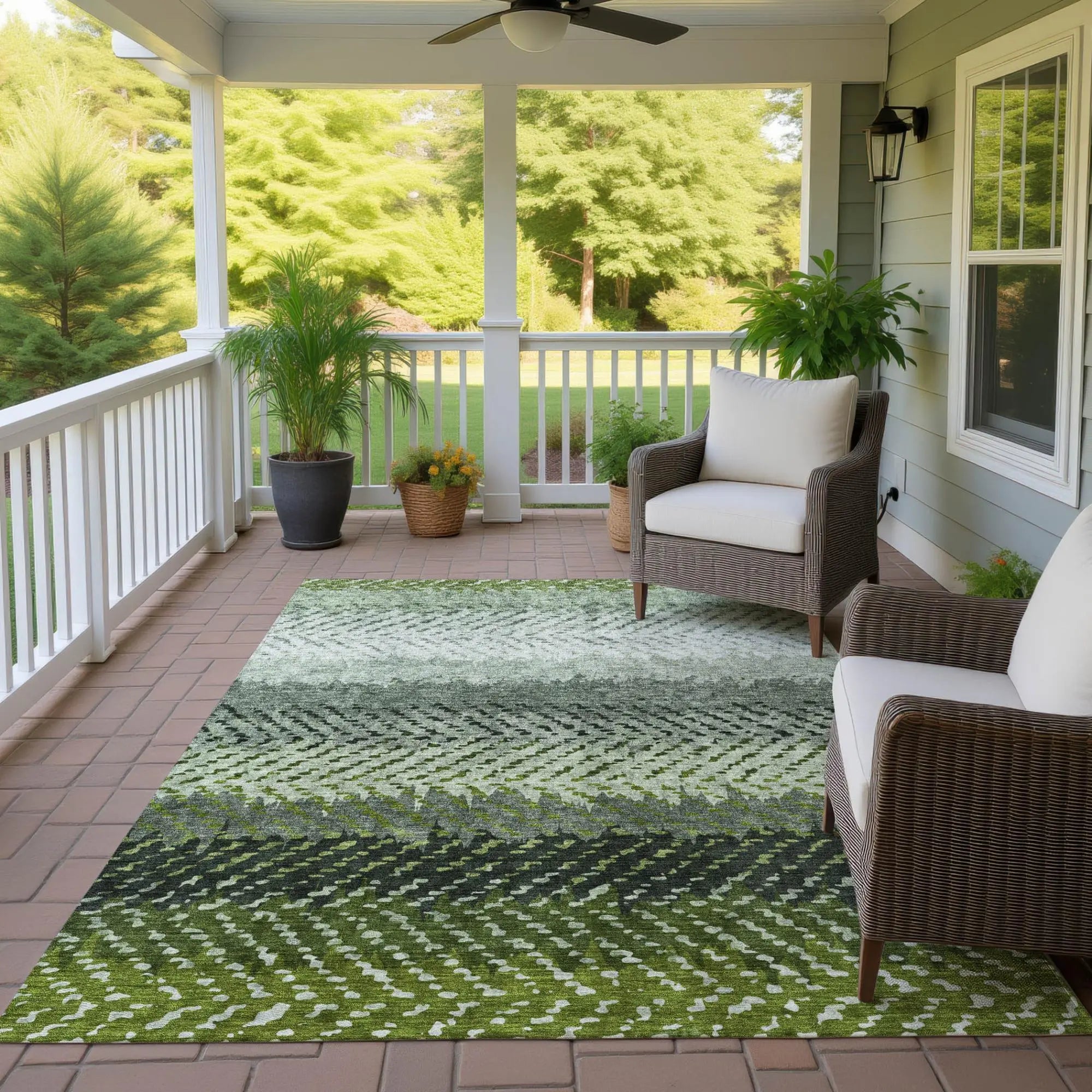 Green and gray geometric outdoor rug, made of durable polypropylene, enhances a cozy porch with modern style.