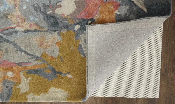 Multicolored abstract rug in soft wool with a textured gray backing, perfect for modern home decor.