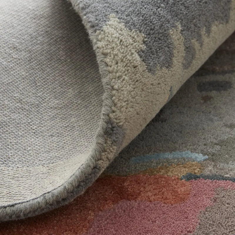 Textured gray area rug with a soft, plush pile and abstract multicolor patterns, perfect for modern interiors.