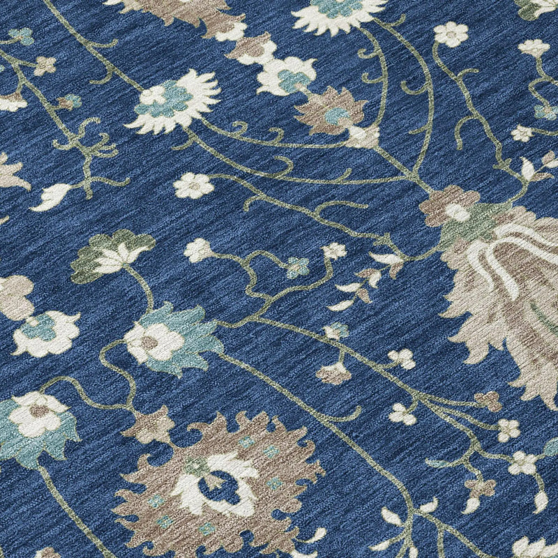 Navy blue floral area rug with beige, light green, and ivory accents; elegant, modern design in soft textile.