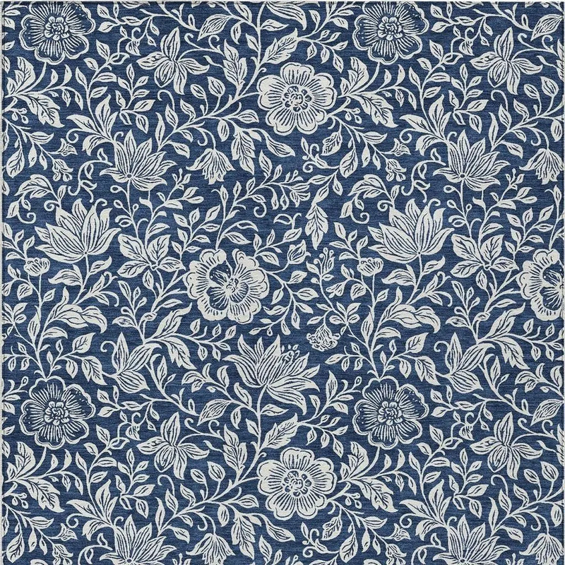 Navy blue floral patterned fabric, featuring intricate white botanical designs, perfect for upholstery or home decor.