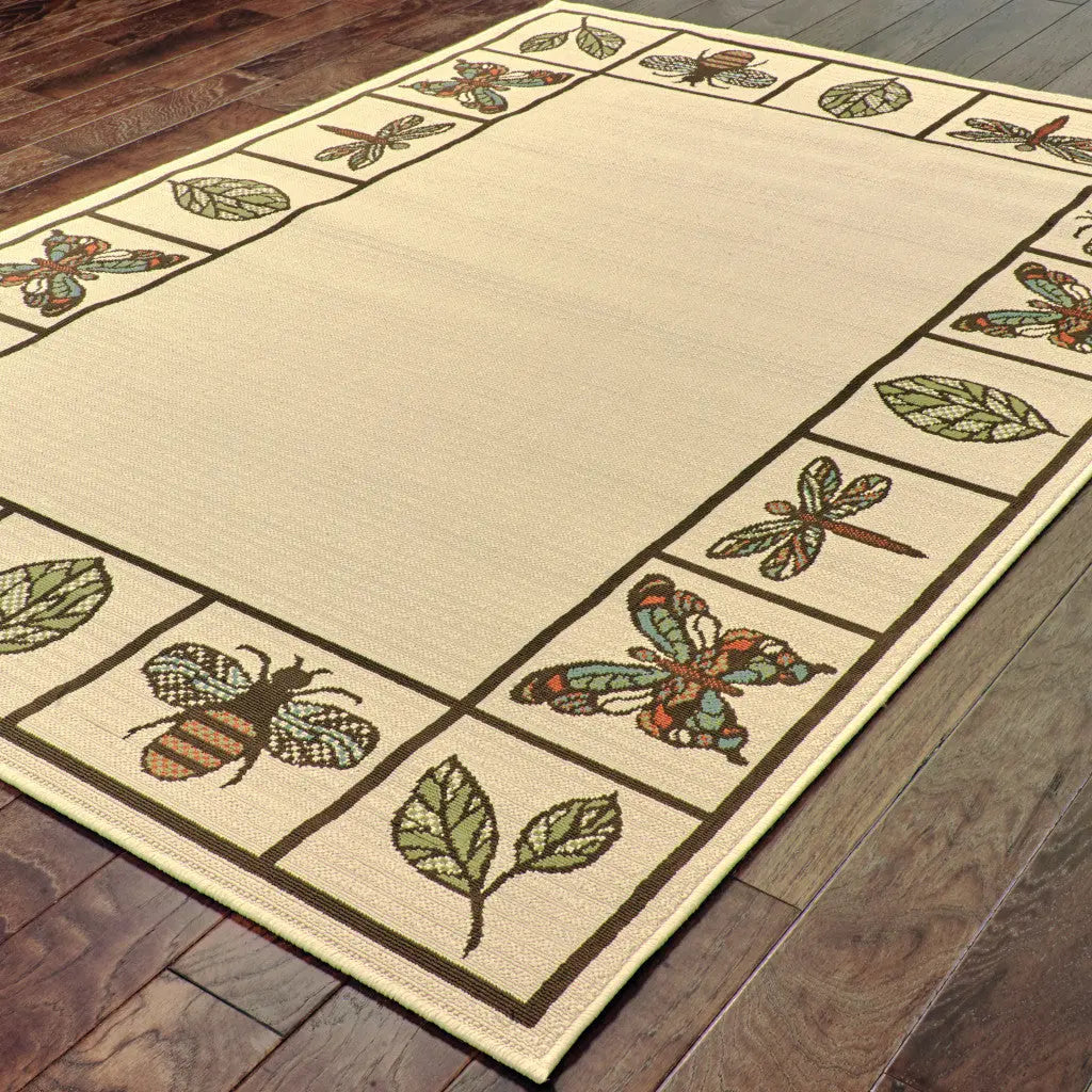 Beige floral area rug with bees and dragonflies, featuring green leaves, woven texture, and natural accents.