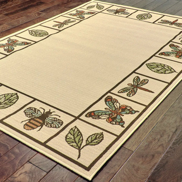 Beige floral area rug with bees and dragonflies, featuring green leaves, woven texture, and natural accents.
