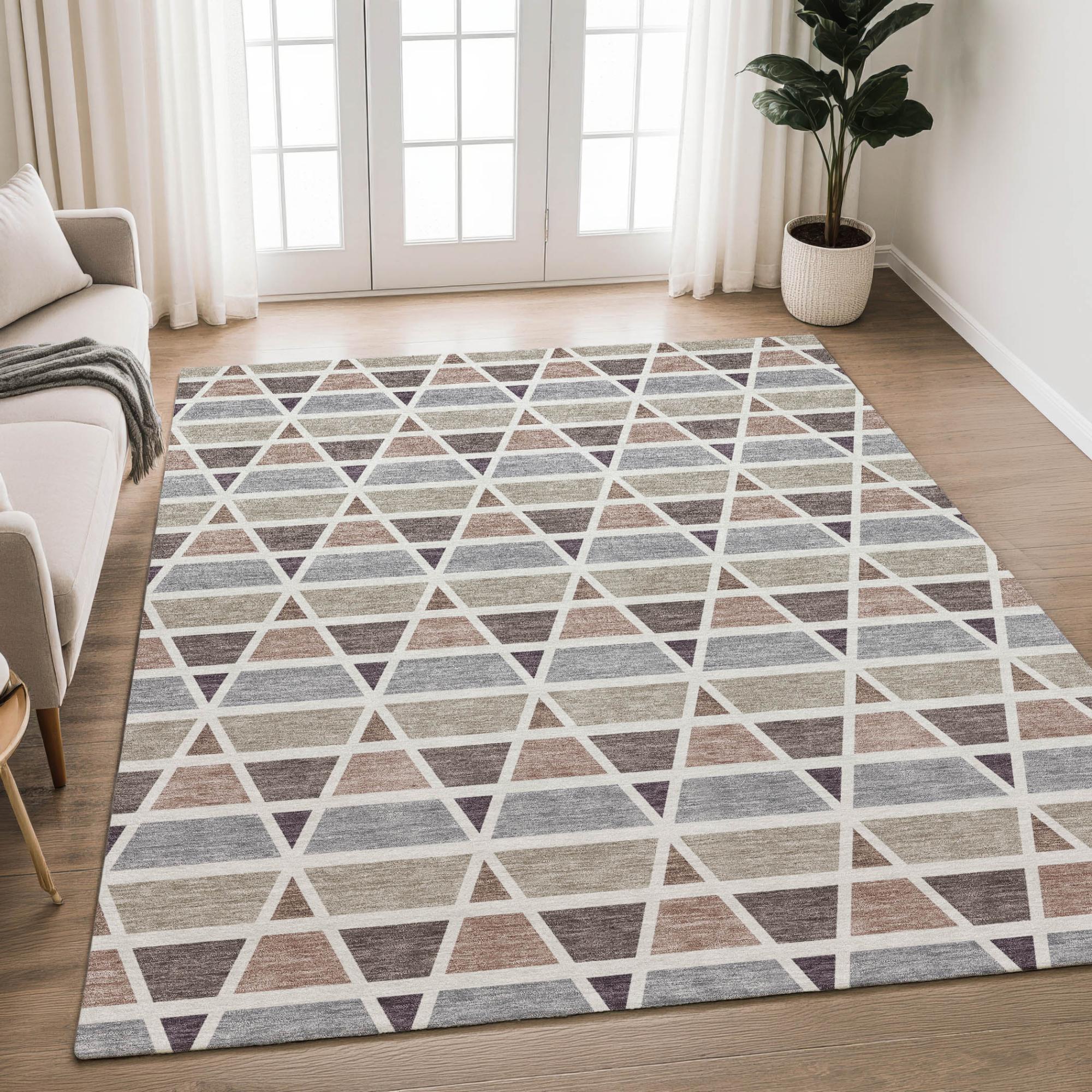 Geo-patterned area rug in beige, gray, and plum, perfect for modern decor. Durable woven material with a stylish design.