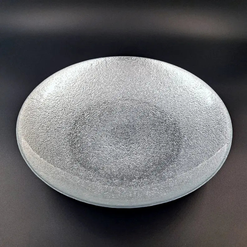 Textured gray glass serving plate, round shape, perfect for elegant dining and decorative displays.