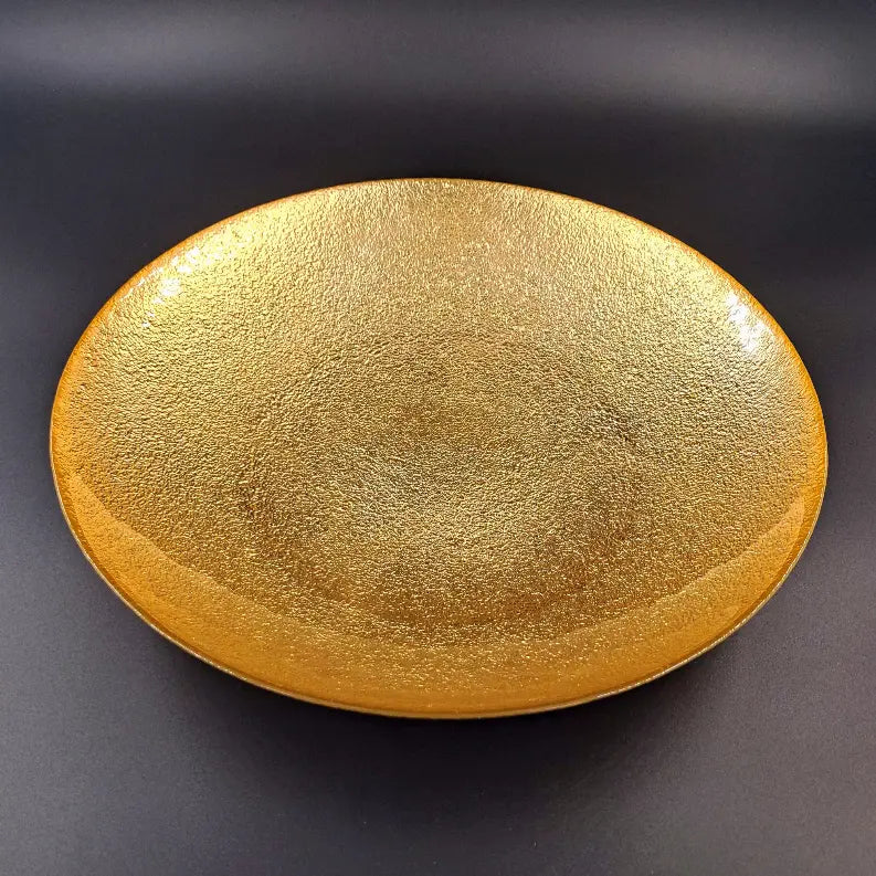 Golden textured oval decorative plate, perfect for modern home decor and elegant table settings.