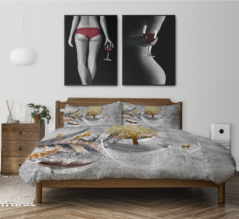 Gray feather-patterned duvet cover set with yellow tree accents, styled on a wooden bed in a modern bedroom setting.
