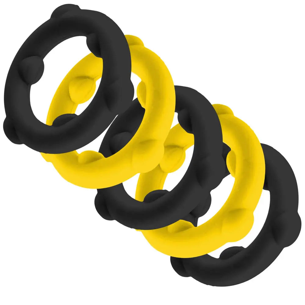 Black and yellow silicone dog chew rings, durable, flexible, ideal for playful dogs.