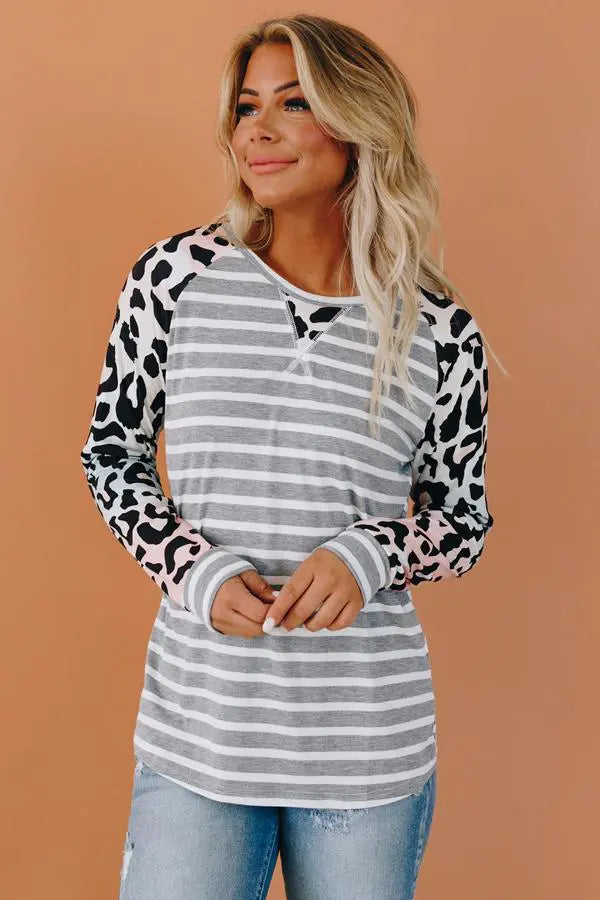 Gray striped long-sleeve top with leopard print sleeves in pink and black, stylish and comfortable for casual wear.