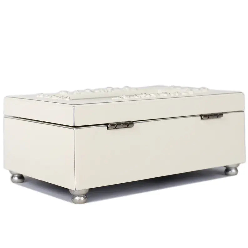 Elegant ivory jewelry box with embossed floral design and silver-tone feet, perfect for organizing accessories.