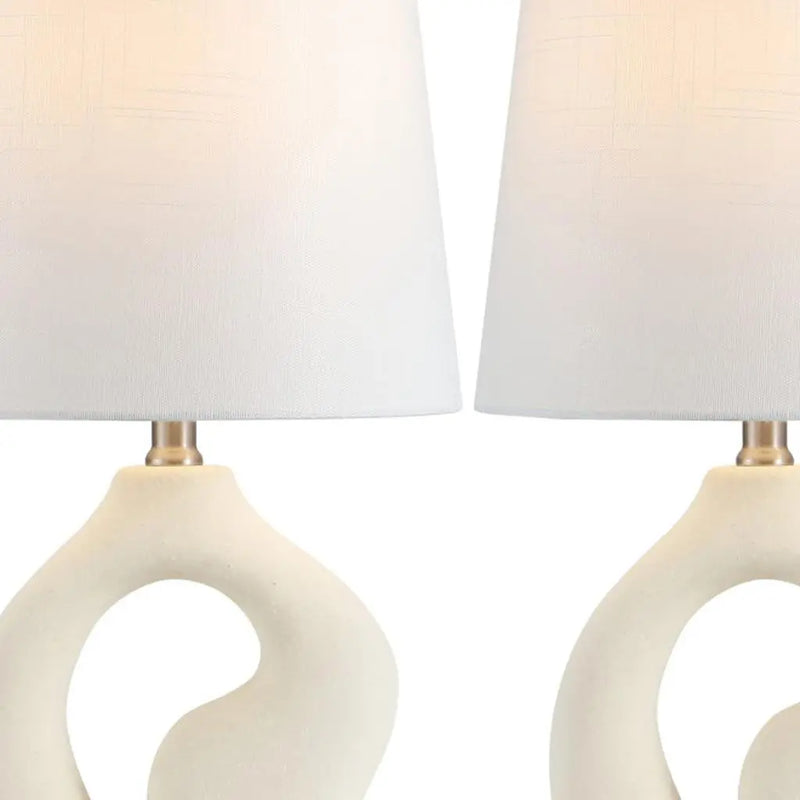White ceramic decorative lamp set with textured ivory fabric shades and gold accents, perfect for modern interiors.
