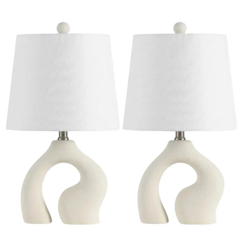 Set of 2 modern beige ceramic table lamps with white fabric shades and curved bases for a stylish accent.