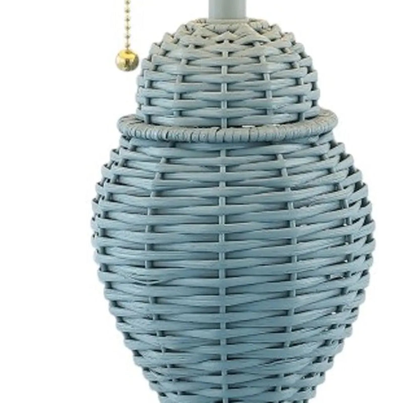 Blue woven table lamp with a unique oval shape and a decorative pull chain. Perfect for modern decor.