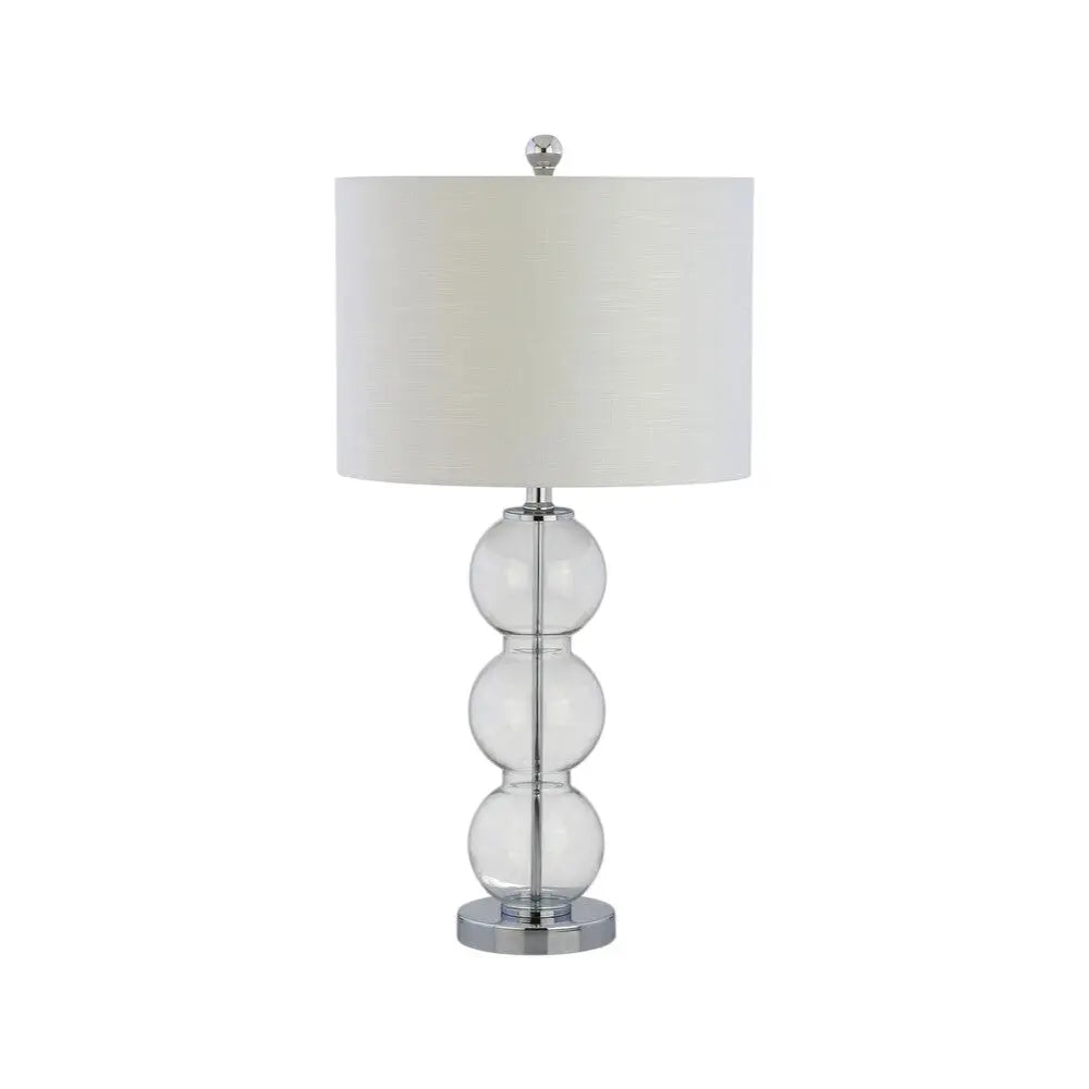 Clear glass table lamp with three spherical accents and a white fabric shade, featuring a sleek chrome base.