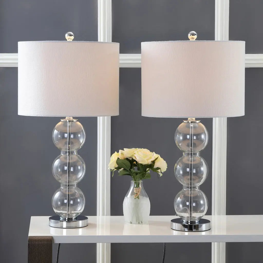 Set of two modern glass table lamps with white fabric shades and crystal clear beaded bases, ideal for stylish decor.