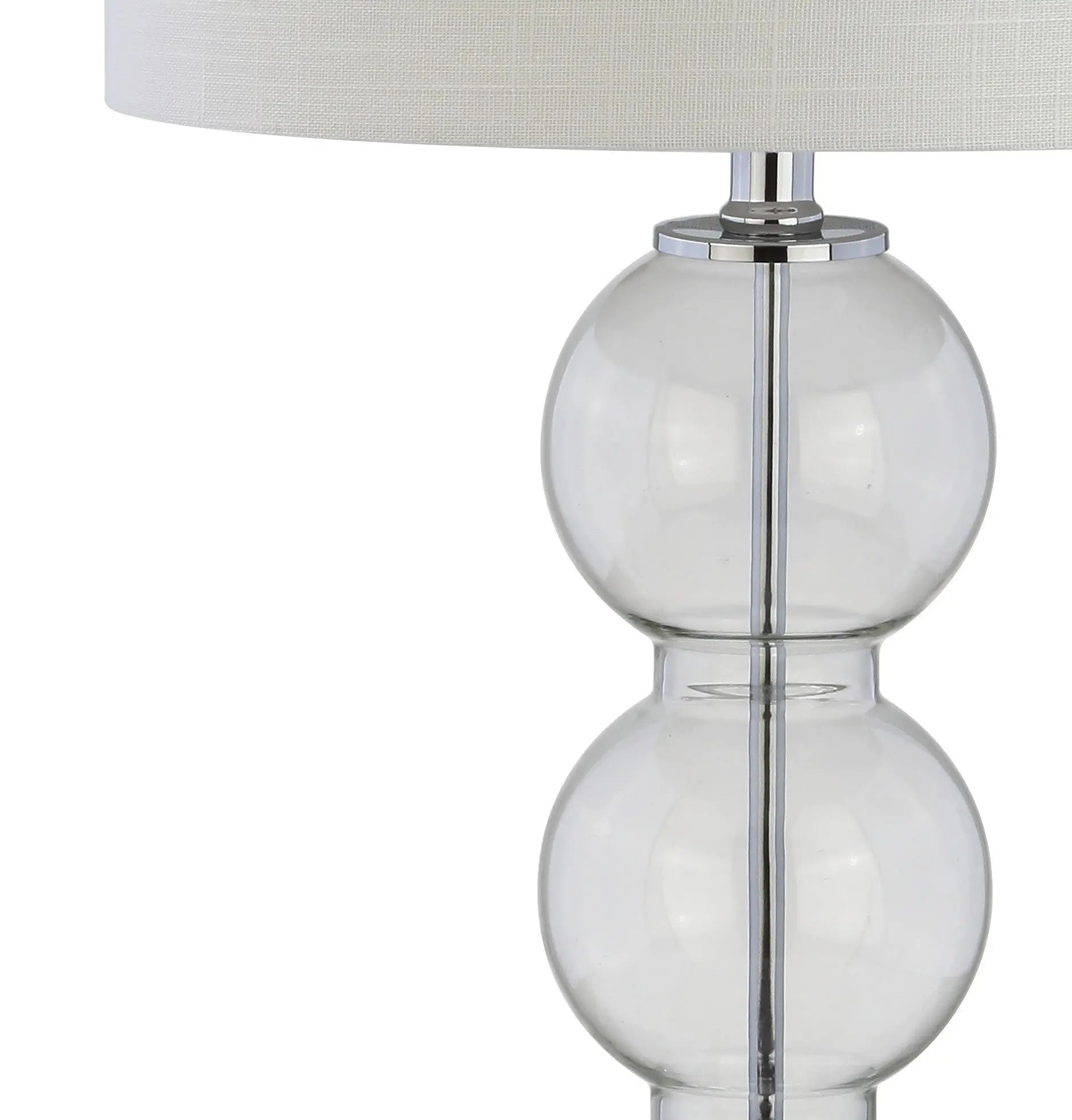 Clear glass table lamp with chrome accents and a white linen shade, stylish and modern design for any decor.